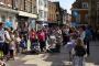 Winchester, Hampshire. The audience for a street performer has relegated the candidate to the background.
