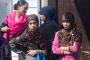 Two teenage girls are made to wait while their mum chats with Labour's parliamentary candidate for Bethnal Green & Bow, Rushanara Ali. Whitechapel market.