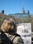 The election debate competes with the Pope on the inner pages of the Canadian newspaper, the National Post, being read on a rooftop deck in Toronto overlooking the CN Tower, Toronto's very tall downtown landmark.
