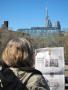 The election debate competes with the Pope on the inner pages of the Canadian newspaper, the National Post, being read on a rooftop deck in Toronto overlooking the CN Tower, Toronto's very tall downtown landmark.