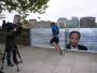 A runner passes a campaign poster for 'no to bike parking tax', which was put outside the Tory HQ on Millbank.