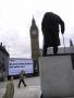 Tourists looking at a statue of Winston Churchill on Parliament Green. In the background a mobile billboard for the Take Back Parliament movement drives past with the words 'No more stolen elections. Fair votes now!'. Take Back Parliament brings together a coalition of different groups and organisations in the call for fair votes. They include POWER2010, Unlock Democracy. Electoral Reform Society and Vote for a Change.