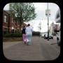 2 girls in pajamas pass by an election poster for Sinn Fein candidate(and party chairman) Gerry Adams on the Falls Road, West Belfast