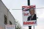 Democratic Unionist Party leader Peter Robinson Election poster in East Belfast. There have been questions about his relationship with property developers and especially his selling of a piece of land for £5 to a developer who then went on to build a number of properties. With this in mind, the for sale sign in the background was too good not to include 