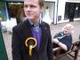 Josh Timminds (17) wears a rosette for the Monster Raving Loony Party. Timminds is a pupil at Royal Latin Grammar School in Buckingham and was taking part in a mock election. Here he stands outside the UKIP headquarters of Nigel Farage during his lunch hour. The  Buckingham constituency was one of the most high profile of the 2010 General Election thanks to Farage's attempt to unseat Commons Speaker John Bercow. The UKIP candidate was also involved in light aircraft crash on polling day. 5th May 2010.
