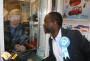 Sam Gyimah engages postmaster John Tolley in the Limspfield High Street (volunteer run) post office