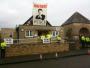 Two protestors unveil a banner on the roof of the polling station in Spelsbury where David and Samantha Cameron voted this morning. The banner read 'Britons, Know Your Place - Vote Eton, Vote Tory'. The Cameron's waited until the protestors were removed before turning up to meet the waiting press. 6th May 2010.